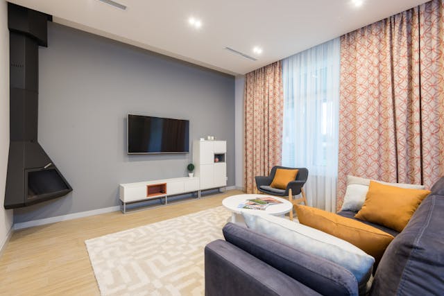 Living room with a couch, TV, and a fire place